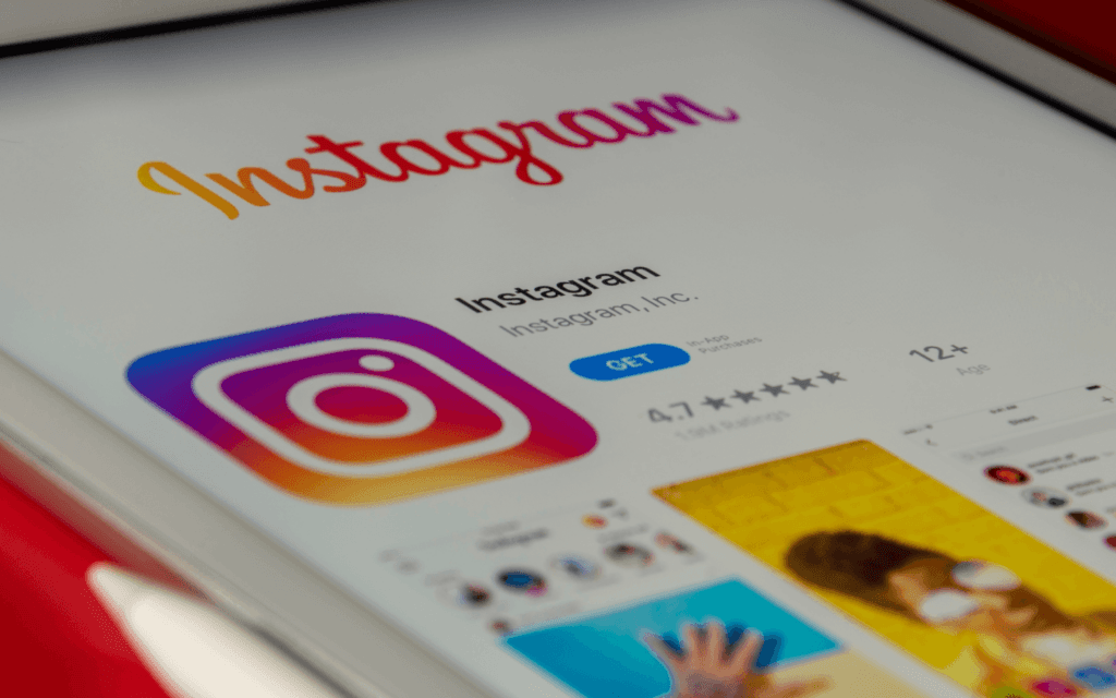"Close-up of Instagram app download page on a tablet, symbolizing the data-rich platform for which the Instagram Insights Report provides detailed analytics."
