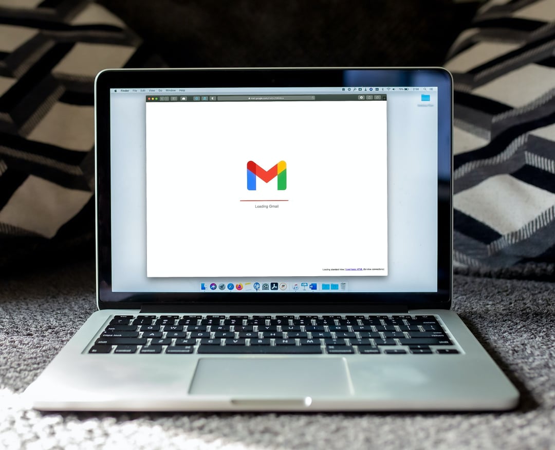 An image of a Macbook loading Gmail.