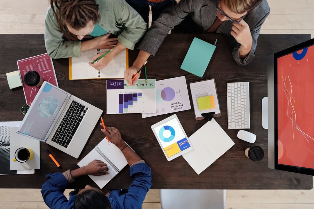 People sitting at a table discussing digital marketing reports