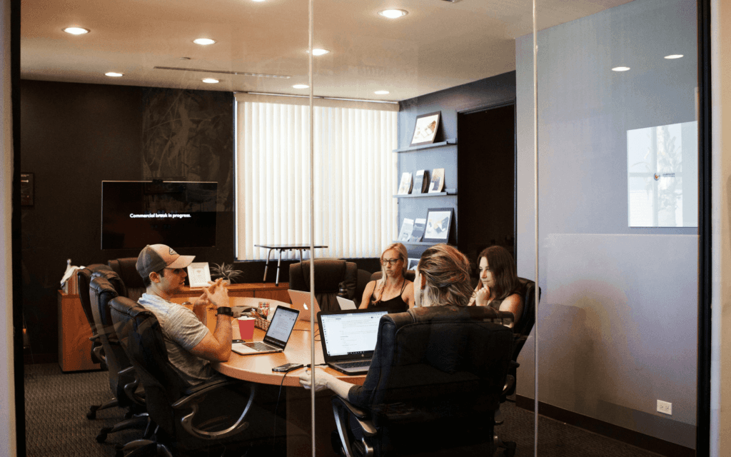 Business professionals engaged in a meeting to discuss the Ideal Customer Profile in a modern conference room.