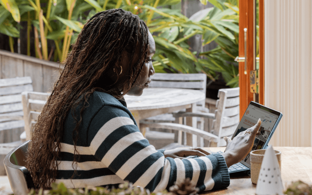 Professional outdoors analyzing SEO data on a tablet, possibly using the Best SEO Report Software, surrounded by a tranquil natural setting.