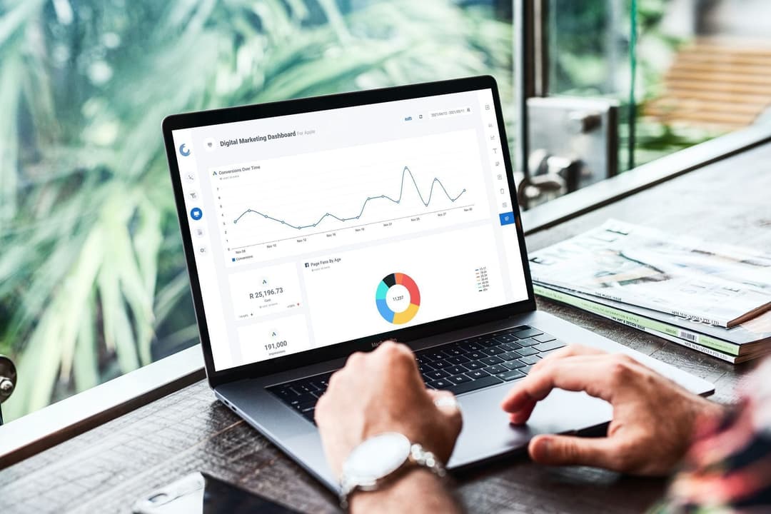 Laptop display with detailed automated marketing reports, highlighting conversion rate graphs and audience segmentation pie charts for strategic analysis.