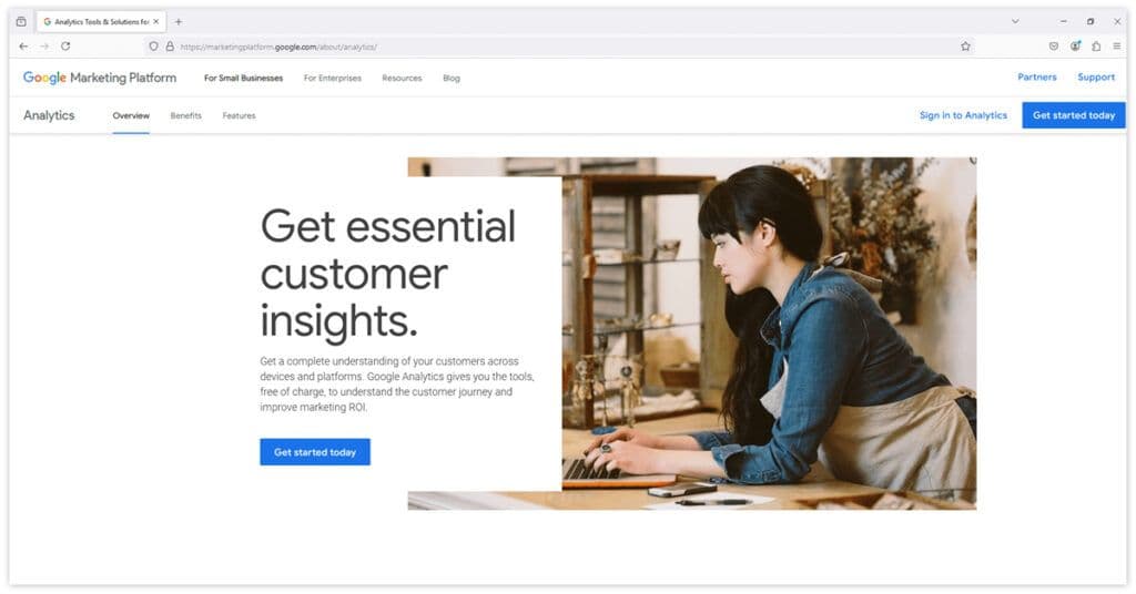 Google Analytics webpage promoting customer insights with tools like Google Looker Studio, featuring a person working on a laptop.