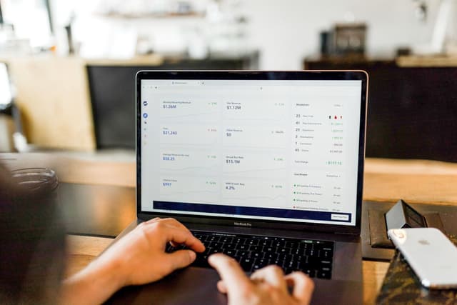 Person sitting with laptop on their lap.