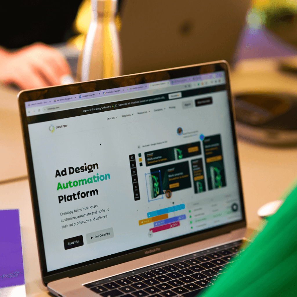 Close-up of a laptop displaying an Ad Design Automation Platform website, highlighting the integration of automation tools in a Digital Agency Workflow.