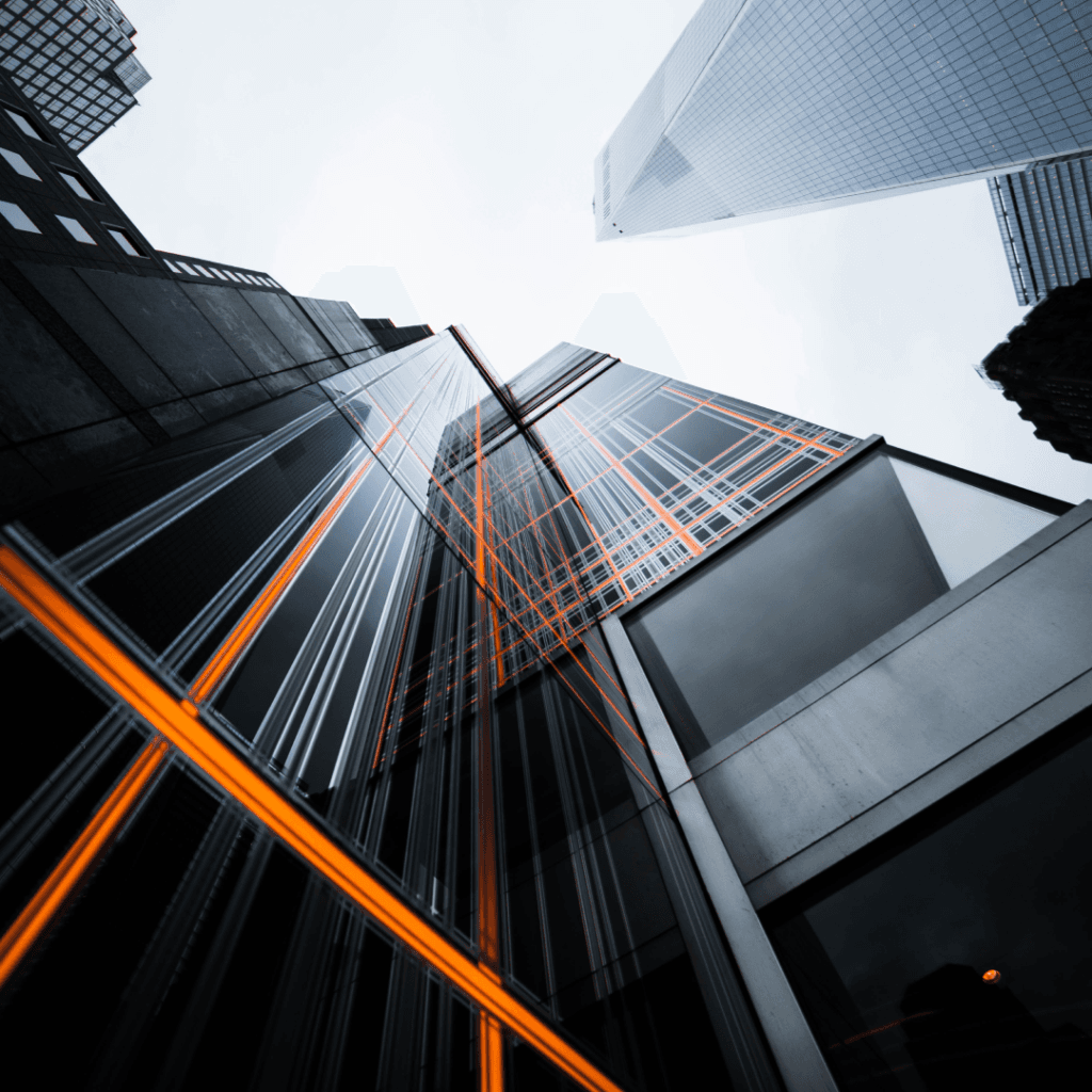 Modern skyscrapers with orange digital overlays representing digital marketing innovations in an urban setting