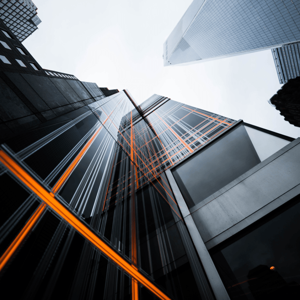 Modern skyscrapers with orange digital overlays representing digital marketing innovations in an urban setting