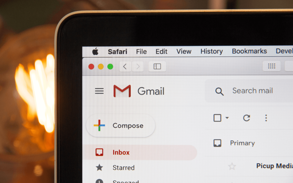 Gmail inbox interface on a laptop screen used by marketers to track and analyze email marketing performance metrics for campaign optimization.