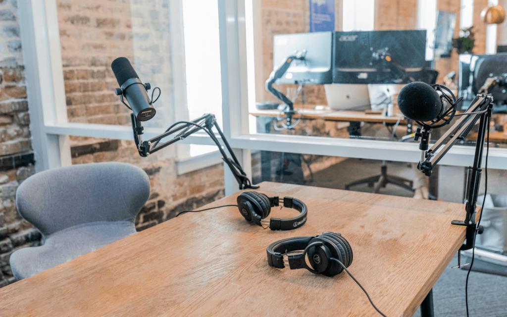 Professional podcasting equipment set up on a wooden table, highlighting the role of podcasting in creating engaging digital marketing content.