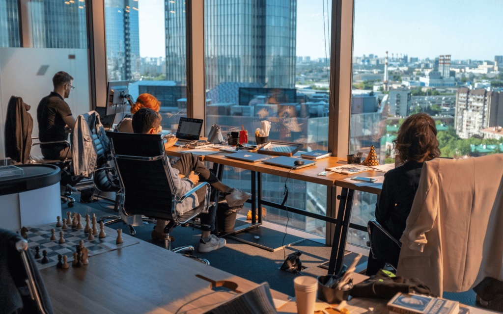 Professionals in a high-rise office setting with city views, potentially strategizing on 'Affiliate Marketing for Beginners.'